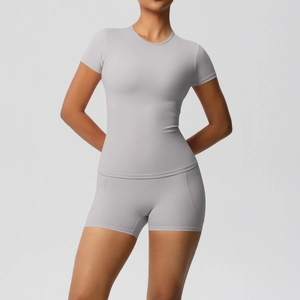 Detailed front view of gray women's short sleeve yoga set with stretch fabric