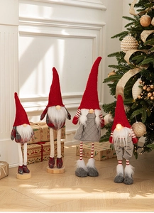 Detail showing four Christmas gnomes with knitted hats and warm glowing LED lights