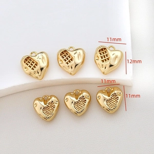 Detail of 11mm and 12mm gold plated heart charms with textured grid and dot patterns