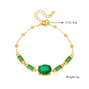 Vintage gold chain bracelet with green oval and rectangular crystals on white background