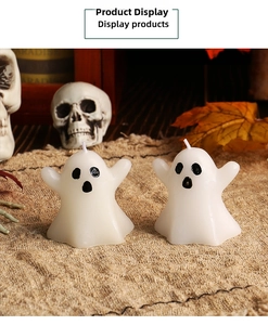 Set of two white ghost candles on burlap with autumn leaves for Halloween decor