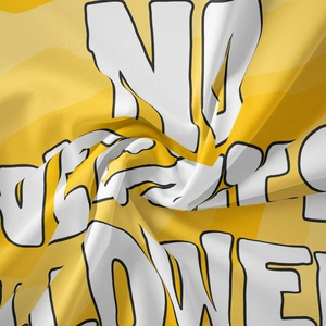 Close-up of bohemian tapestry fabric with bold yellow and white street art graffiti