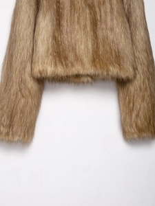 Detailed view of the soft faux fur texture on the hem and cuffs of the brown coat