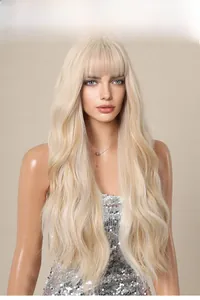 Close-up of wavy blonde synthetic wig with bangs and silky texture on a mannequin