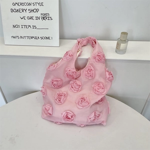 Detail of 3D rose fabric flowers on a pink canvas shoulder bag for a romantic aesthetic