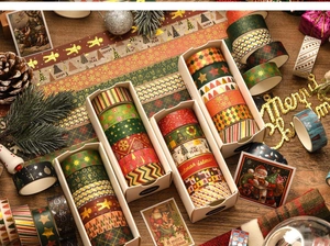 Close-up of Christmas washi tape set with gold foil patterns in a festive gift arrangement