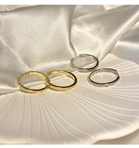 French style S925 sterling silver hoop earrings in gold and silver on white ceramic