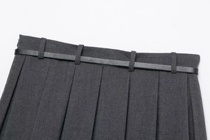 Detail of dark grey pleated skirt fabric with a slim black leather belt and fine texture