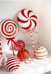Macro view of red and white striped Christmas candy cane ornaments with glitter texture