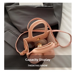 Detail showing internal capacity of the pink mini bag with magnetic closure and items