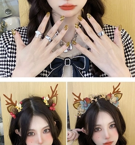 Close-up of reindeer antler hair clips with snowflake and pinecone festive details
