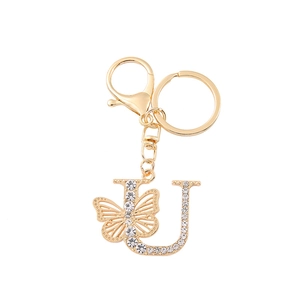 Golden keychain with crystal butterfly and letter J pendant on a white background