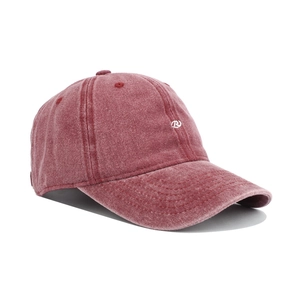 Close-up of vintage washed red cotton baseball cap with white embroidered R logo detail
