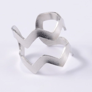 Macro view of silver double-layered wavy ear cuff with minimalist geometric design