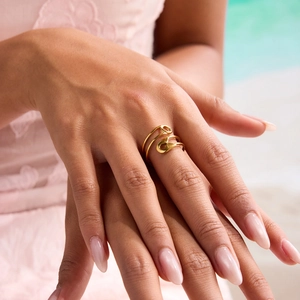 Detail of 18K gold stainless steel multi-layered paperclip ring worn by a model