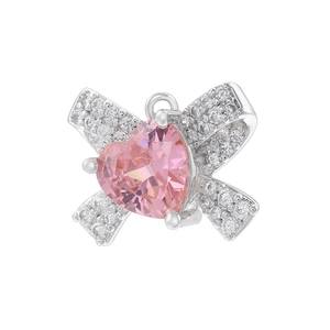 Close-up of a silver bow pendant with a pink heart gemstone and clear zircon accents