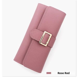 Detail of rose red long wallet with pebbled leather texture and gold buckle