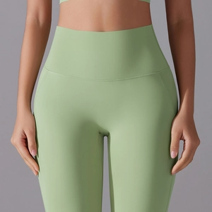 Avocado green high-waist yoga pants with wide waistband and reinforced stitching
