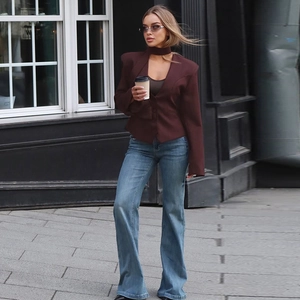 Fashionable dark brown slim cardigan with neck loop shown in an urban street setting