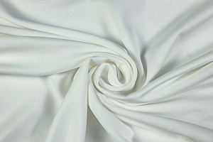 Close-up of white ruched fabric texture with silky sheen for a backless bodycon dress