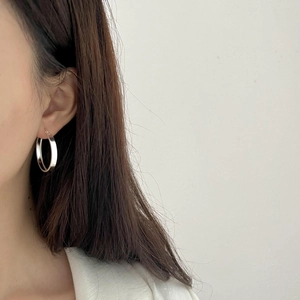 Classic S925 sterling silver hoop earrings with high-polish finish on a model