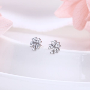 Close-up of S925 sterling silver four-leaf clover stud earrings with pavé zircons