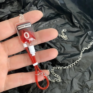 Macro detail of a creative blood bag pendant with red fluid and type O marking