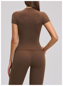 Rear view detail of dark brown moisture-wicking yoga top and high-waist fitness leggings