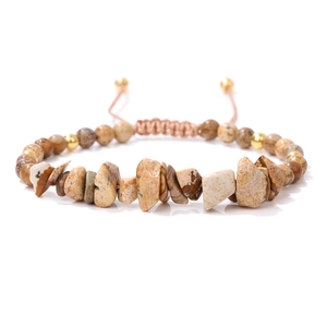 Detail of hand-woven bracelet with natural gravel stones and adjustable cord