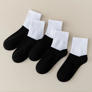 Five pairs of kids breathable cotton socks in a stylish black and white contrast design