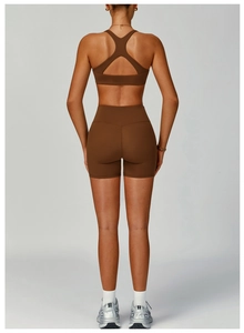 Detail of high-waist brown yoga shorts and racerback sports bra with seamless texture