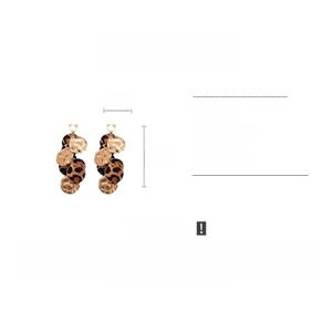 Detail view of leopard print leather earrings with gold metal disks showing 11cm length