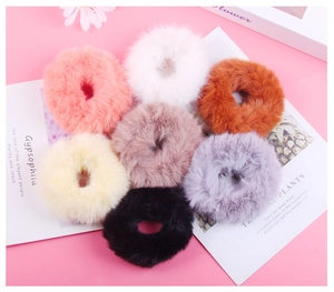 Detailed flat lay of soft faux rabbit fur scrunchies in seven assorted pastel colors