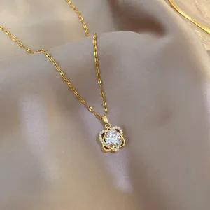 Macro detail of gold heart pendant with crystal inlay on soft purple silk fabric