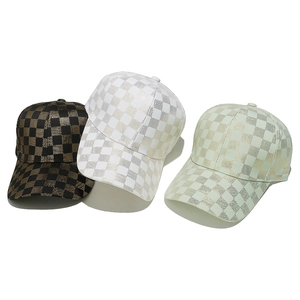 Three metallic checkerboard baseball caps in black, white, and green with curved brims