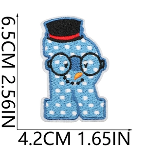 Detail showing cartoon snowman embroidery patch with size measurements in centimeters and inches