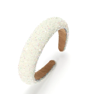 Sparkly white padded headband with glitter texture and comfortable brown lining