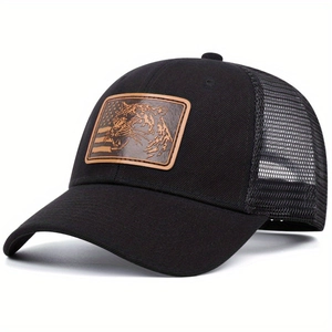 Retro black trucker hat with tiger leather patch and breathable mesh back in side view