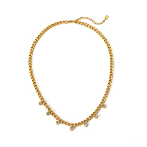 Detail of golden Cuban chain necklace featuring seven sparkling round zircon pendants