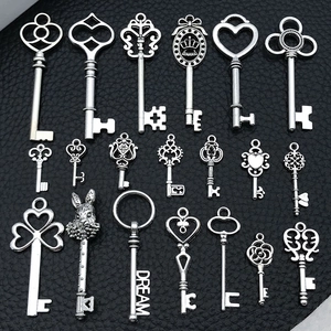 Flat lay of assorted antique silver alloy key pendants with diverse vintage designs