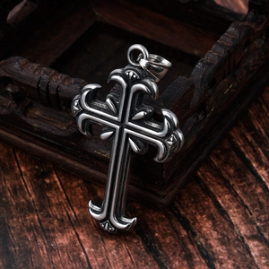 Gothic vintage engraved stainless steel cross pendant on antique wooden box