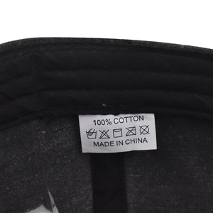 Macro view of 100% cotton material and care label inside this washed baseball cap