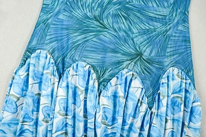 Close-up of blue floral print patchwork and pleated texture on slim-fit A-line dress