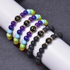 7 Chakra stone and black lava rock beaded bracelets with golden symbolic accent beads