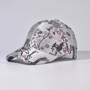 Detail of silver silk baseball cap with floral embroidery and Boy cursive lettering