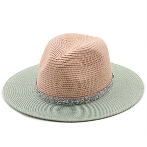 Detail of pink and mint green woven straw hat featuring a sparkling silver glitter band