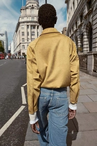 Rear view of yellow suede bomber jacket showing sharp back tailoring and clean stitching