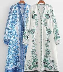 Detail of V-neck printed long dresses with lantern sleeves and button-down front
