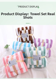 Detailed texture of striped coral fleece towel set in multiple soft pastel colors