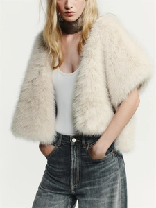 Detail of soft cream faux fur texture on a short-sleeved winter shawl vest for women